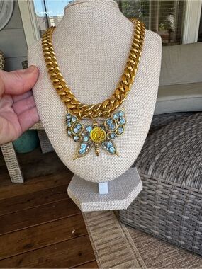 Gold-Tone Butterfly Pendant Necklace with Light Blue Crystals and logo